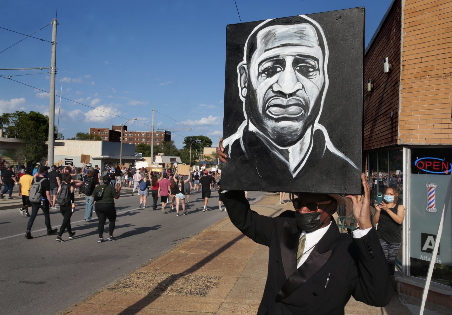 Protesters march through the Delmar Loop